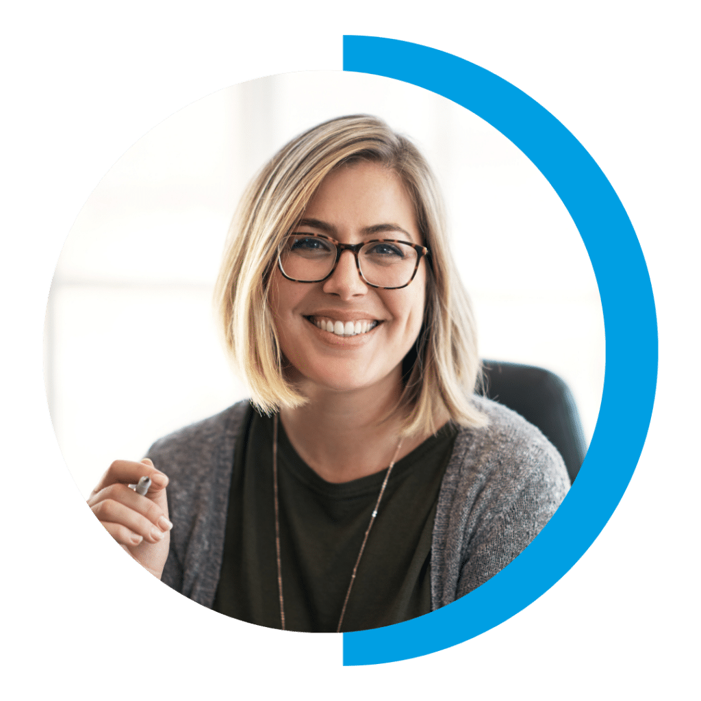 Woman smiling while holding pen