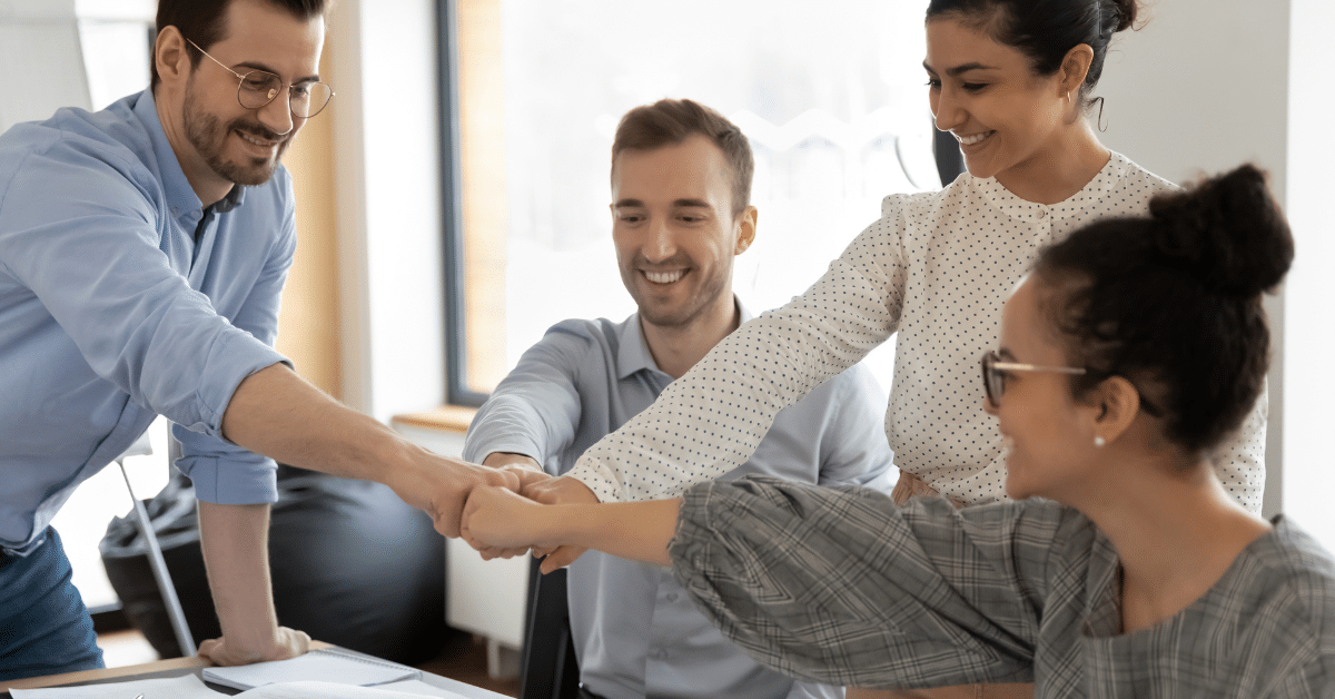 People fist bumping in office