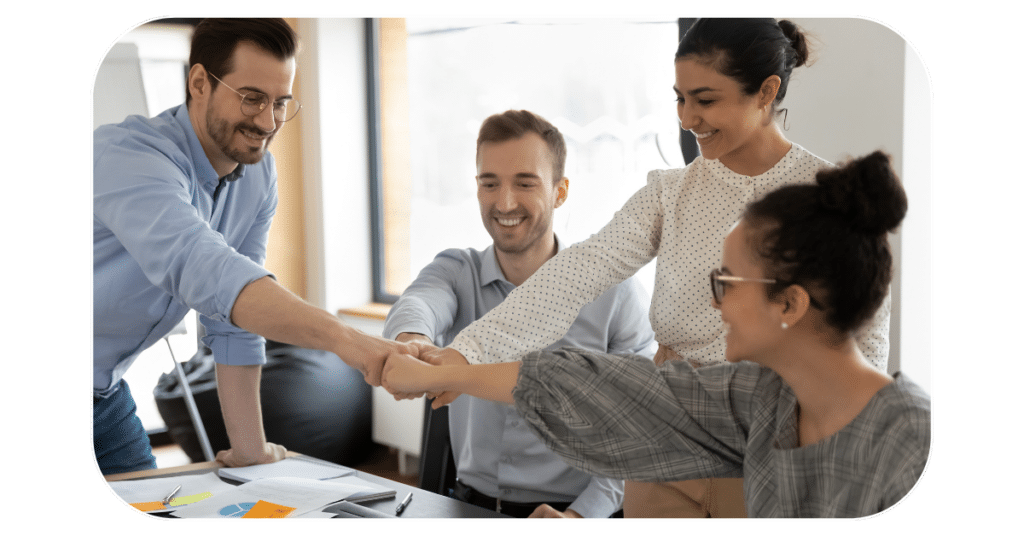 People fist bumping in office